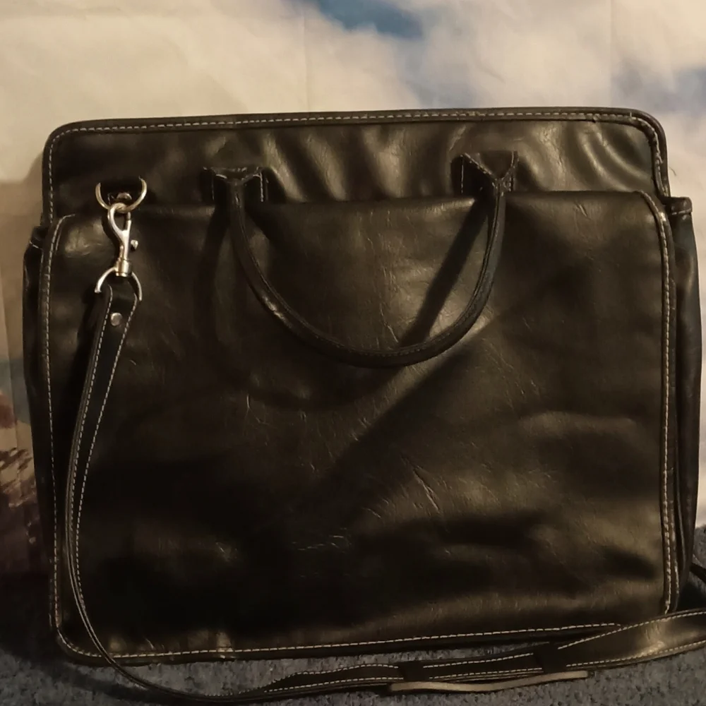 Global New Beginnings Leather laptop bag with pockets. Black bag includes strap